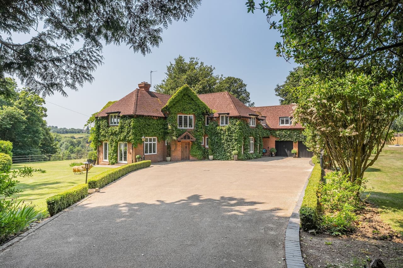 Old Lakenham, a large ivy-covered house with a long gravel drive