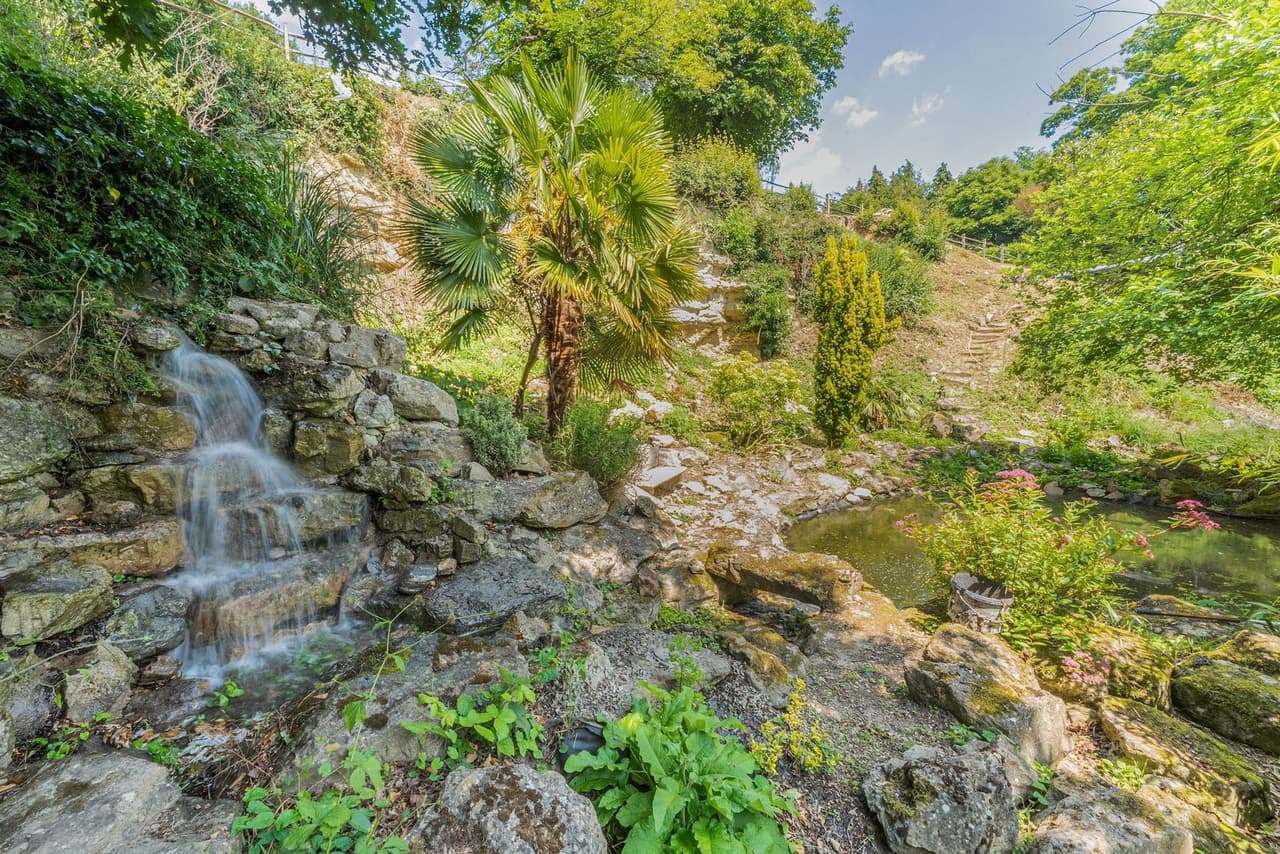 Gardens with a rock waterfall and pond