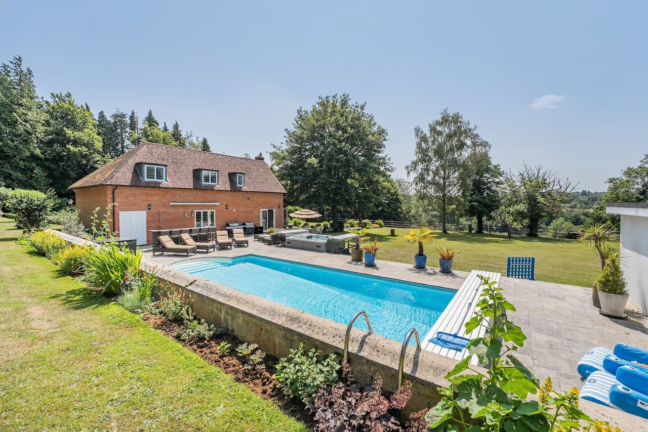 The outdoor pool and terrace in front of the house
