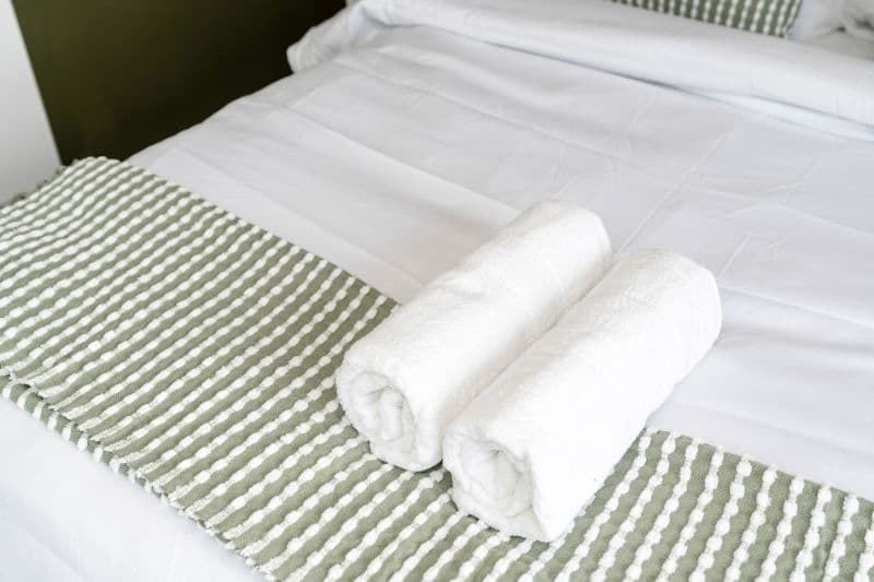 Fresh towels on a made bed