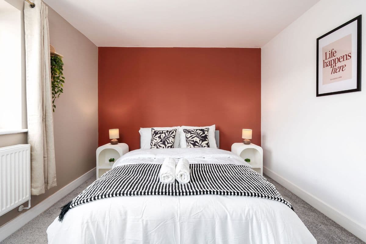 A double bed made up with fresh linen and towels